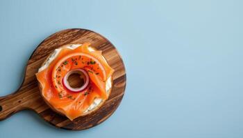 minimalist food photography of a smoked salmon bagel on a wooden board, cream cheese with red onion, soft blue background photo