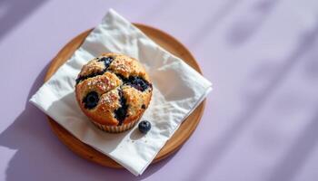 minimalist food photography of a blueberry muffin on a white napkin, crumbly with sugar topping, soft lavender background photo