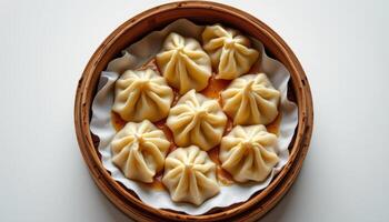 minimalist food photography of dumplings on bamboo steamer with chili oil, soft white background, natural daylight, top down view photo