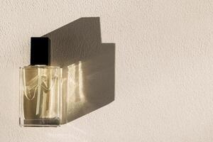 Close-up of a transparent glass perfume bottle with a black lid. A mock-up of a vial of fragrant water on a white background photo