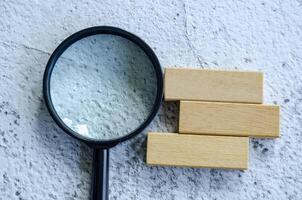 Magnifying glass with customizable space on wooden block for text photo
