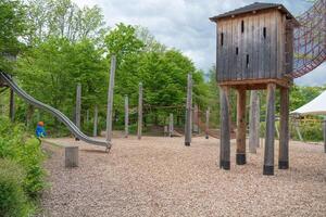 Child Enjoying Adventure Playground with Slide photo