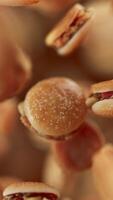 Animation of a group of burgers. Many burgers slowly rotate in the background in space. Vertical composition. Defocus. Close-up. video