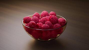 A glass vase filled with raspberries spinning in a circle. Looping animation. Close-up. Defocus. video