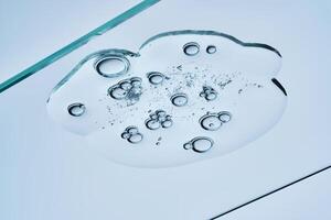 The texture of a clear shower gel or shampoo with bubbles. View from below. photo