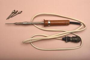 A vintage soldering tool featuring a silver-coated tip photo
