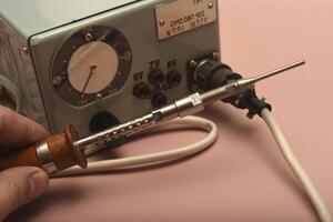 Retro soldering station. old soldering iron with a silver tip. photo
