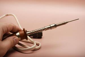 A traditional soldering iron with a silver-plated tip photo