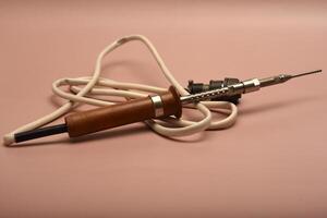 An aged soldering implement with a silver-plated point photo