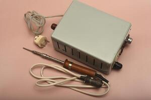 Retro soldering station. An old soldering iron with a silver tip. photo