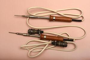 A timeworn soldering tool equipped with a silver tip photo
