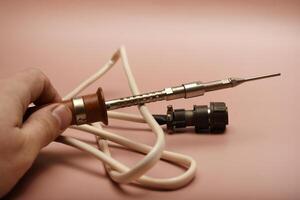 An ancient soldering implement displaying a silver tip photo