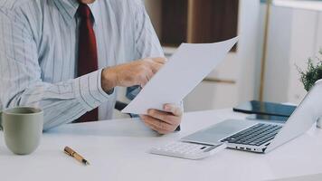 A man in a business suit is holding a piece of paper video