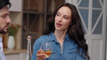 Couple enjoys a relaxing evening with wine in a cozy kitchen setting video