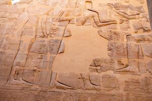 Karnak Temple in Luxor, Egypt. Hieroglyphs and Art on pillars and walls. Temples, , chapels, and buildings in Karnak Temple Complex photo