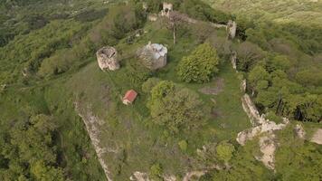 -Ancient Bochorma fortress complex in Georgia surrounded by scenic Caucasus mountains. Medieval site features stone fortifications, domed church, panoramic views over Iori River valley video