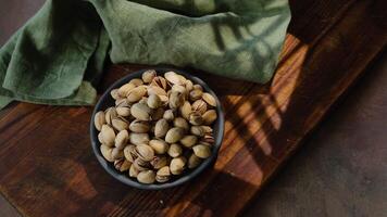 Roasted pistachios nuts in bowl. Top view. video
