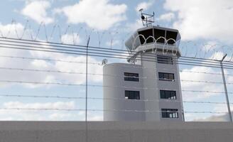 Angled View of Air Traffic Control Tower Behind Barbed Wire Fence. photo