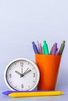 Minimalist photo showing stationery elements like clock and pens with bold colors conveying back to school vibes daily planning focus morning routine and kids learning visual perfect for creative