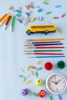 School concept layout with multicolored pens bright yellow toy bus and wax crayons highlighting student imagination creative tools learning process kids back to school routine and vibrant composition photo