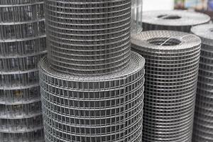 Roll of metal mesh with rectangular cells on the window of a construction store photo