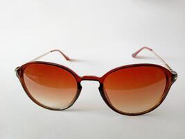 Close up of brown sunglasses isolated on a white background photo