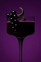 A luxurious blackcurrant cocktail in a modern dark-stemmed glass, garnished with a cluster of glossy blackcurrant berries and two abstract crescent-shaped green fruit pieces. photo