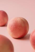 Minimalist studio photo of a single ripe peach with visible water droplets on the surface