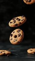 Chocolate cookies floating on air with chips in dark background photo