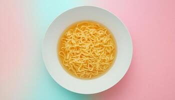 Noodle soup for simple lunch on white plate on pink background photo