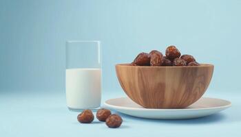 Fresh dates fruit on wooden bowl and a glass milk for healthy breakfast photo