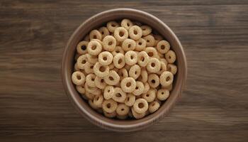 Cereal rounded ring wholegrain and on wooden bowl in brown table dark background photo
