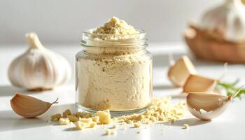 Garlic Powder in Glass Jar with Whole Garlic photo