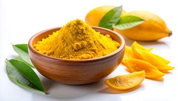 Turmeric Powder in Bowl with Mango Fruit and Leaf photo