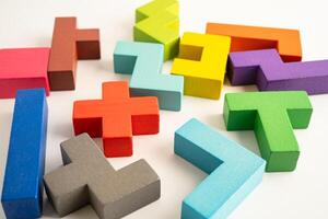 Logical thinking and problem solving creative business solution concept, wooden puzzle geometric shape block photo