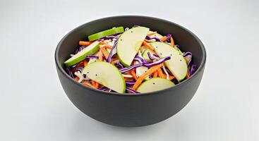 Creamy Apple Slaw in a Textured Charcoal Ceramic Bowl Against White photo