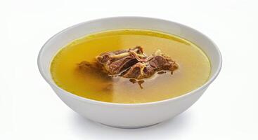 A bowl of soup with meat in it photo