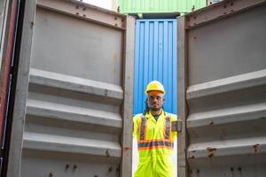 Engineer man checking containers box in in industry containers yard, Foreman dock worker inspecting containers box photo