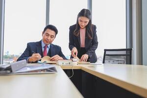 Collaborative Meeting in Modern Office Space, Professional business meeting in office environment, Asian businesspeople meeting in modern office, Teamwork and brainstorming concepts photo