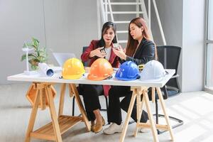 Female engineer and architecture working meeting and brainstorming together at project site photo