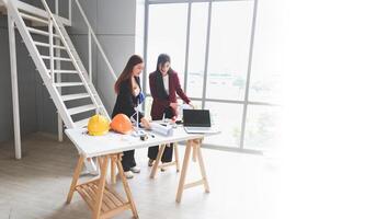 Team of Female engineer and architecture working meeting and brainstorming together at project site photo