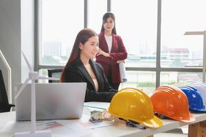 Female engineer and architecture working meeting and brainstorming together at project site office photo