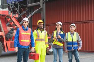 Group of engineer and foreman worker team in industry containers yard, Dock workers collaborating at shipping container cargo photo
