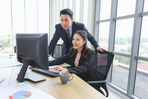 Supervisor training and suggesting about work to colleagues, Asian businesspeople team meeting in modern office, Professional business meeting in office, Teamwork and brainstorming concepts photo
