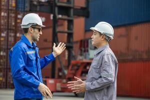 Foreman Dock Worker Team Inspecting Containers Boxes at Industrial Site, Engineer man Team in Safety Gear Control Containers Box at Container Cargo photo
