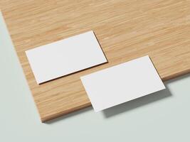 Two white business cards placed on a wooden background, with soft shadows adding depth to the clean, modern design. photo