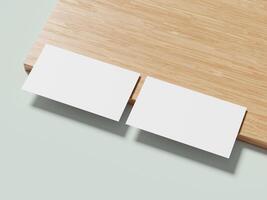 Minimalist white business card placed on a light wooden table, casting a soft shadow for a professional and clean look. photo