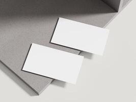 A sophisticated business card mockup placed on a beige cement block with subtle shadows, perfect for luxury branding. photo