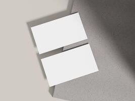Business card mockup positioned on a grey cement block with lighting, perfect for modern branding presentations. photo