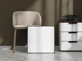 White poster frame mockup on the floor in a modern interior with a beige chair and a drawer unit, illuminated by natural light. photo